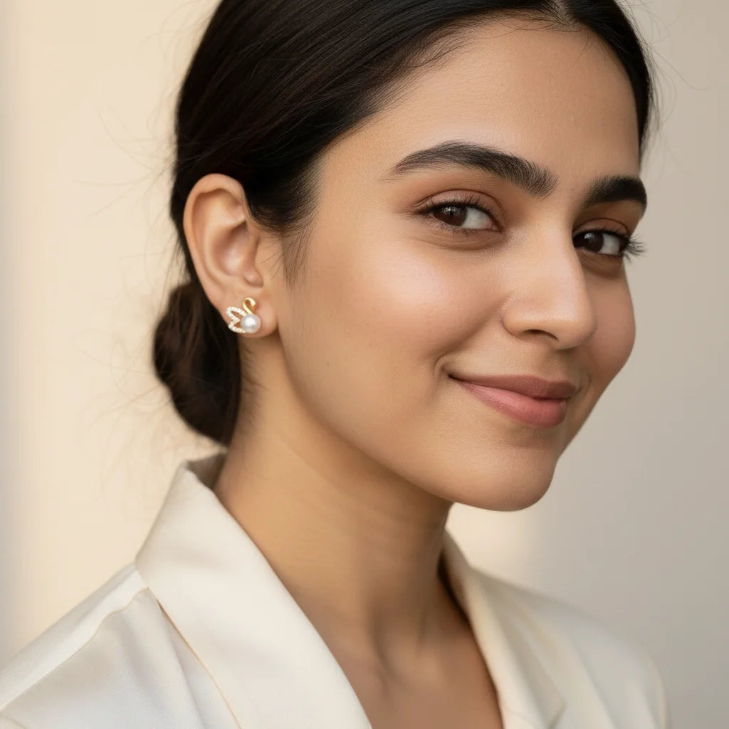 Pearl Swan Studs — Worn Close-up